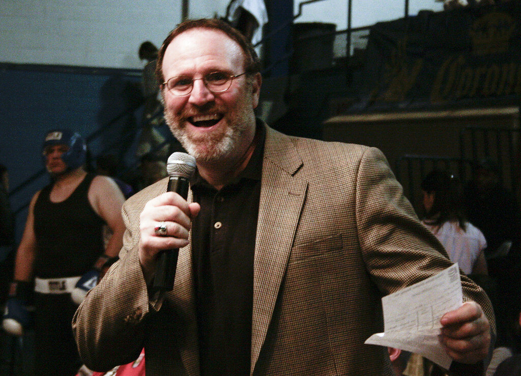 A ring announcer speaking into a microphone at the Chicago Golden Gloves