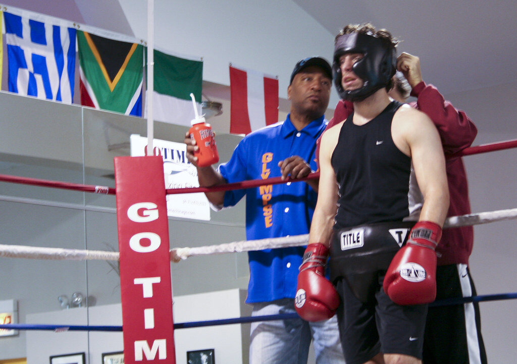 A boxer and coaches preparing in the corner of a Chicago boxing ring