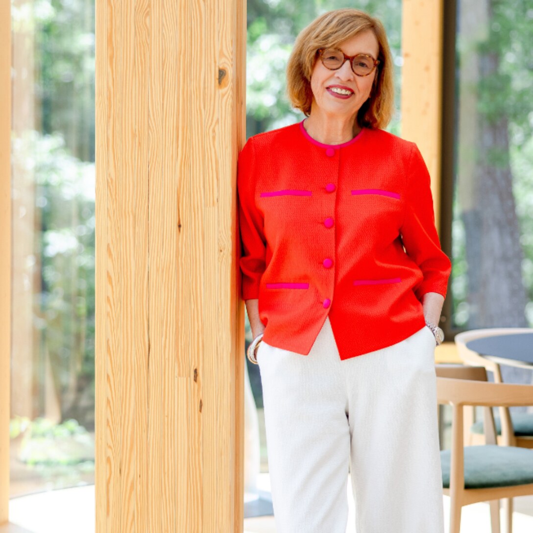 Ann Drake standing in the timber-framed great room of the Women's Leadership Center at Williams Bay